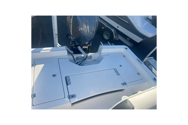 Slide: The Image of 2026 Tidewater 2210 Carolina Bay boat with outboard motor and storage compartments. - 14