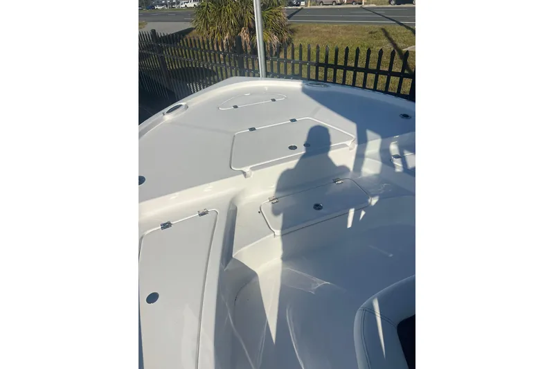 Slide: The Image of 2026 Tidewater 2210 Carolina Bay boat deck with storage compartments and shadow. - 18