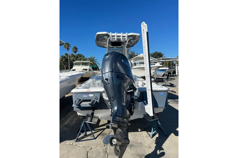 Slide: The Image of 2026 Tidewater 2210 Carolina Bay boat with Yamaha outboard motor, displayed outdoors. - 2
