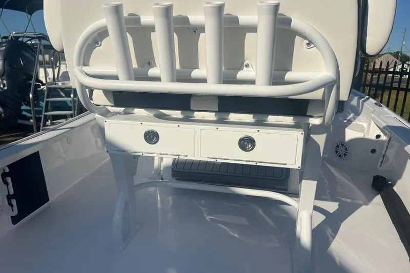 Slide: The Image of 2026 Tidewater 2210 Carolina Bay boat interior with rod holders and storage drawers. - 6