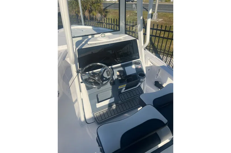 Slide: The Image of 2026 Tidewater 2210 Carolina Bay boat cockpit with steering wheel and controls. - 7