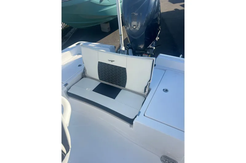 Slide: The Image of 2026 Tidewater 2210 Carolina Bay boat interior with seating and motor. - 9