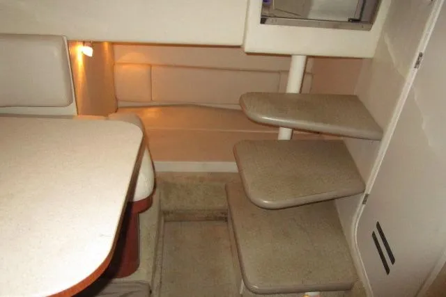 Slide: The Image of 2005 Sea Ray 290 Amberjack cabin interior with steps and seating area. - 13