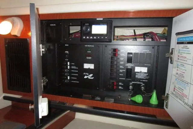 Slide: The Image of Electrical panel inside a 2005 Sea Ray 290 Amberjack boat, featuring various controls and switches. - 17