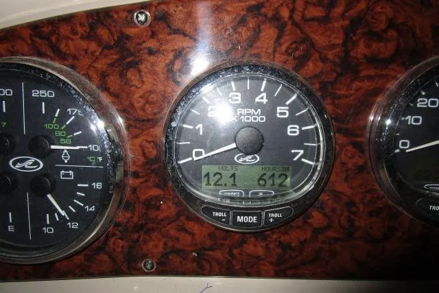 Slide: The Image of Dashboard gauges of 2005 Sea Ray 290 Amberjack boat, showing RPM and voltage. - 18