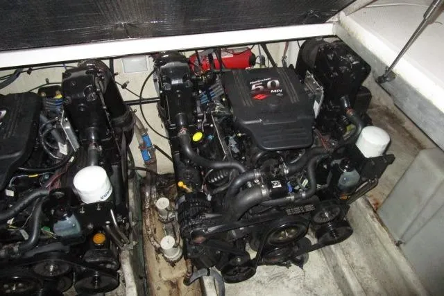 Slide: The Image of Engine compartment of a 2005 Sea Ray 290 Amberjack boat, featuring dual engines. - 24