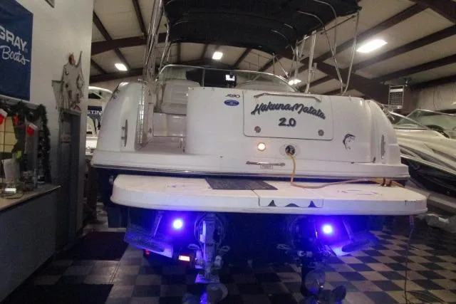 Slide: The Image of 2005 Sea Ray 290 Amberjack boat with illuminated stern in indoor showroom. - 3