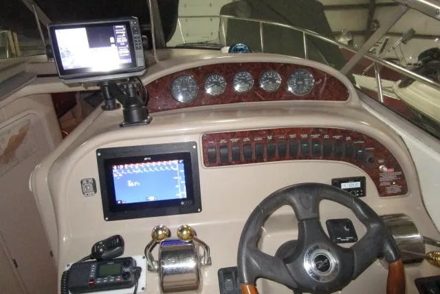 Slide: The Image of 2005 Sea Ray 290 Amberjack boat dashboard with navigation equipment and controls. - 6