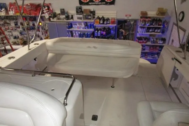 Slide: The Image of 2005 Sea Ray 290 Amberjack boat interior with seating and storage shelves in background. - 7