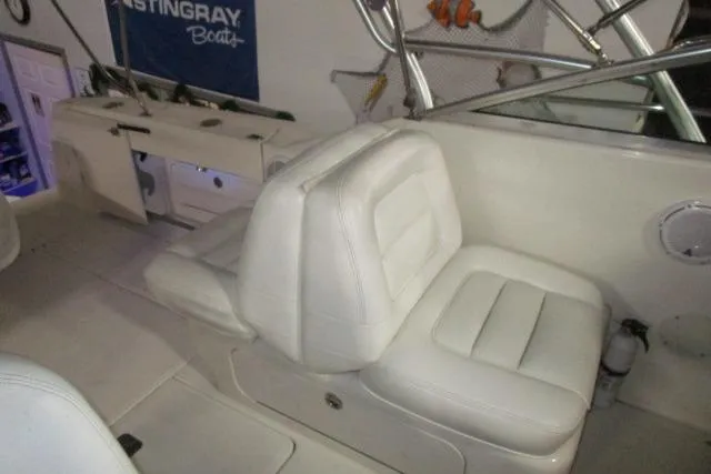 Slide: The Image of 2005 Sea Ray 290 Amberjack interior with white seating and fishing equipment. - 8