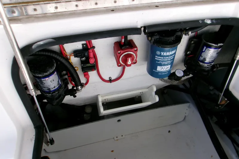 Slide: The Image of 2014 Sportsman Heritage 241 Center Console boat engine compartment with Yamaha fuel filters. - 11