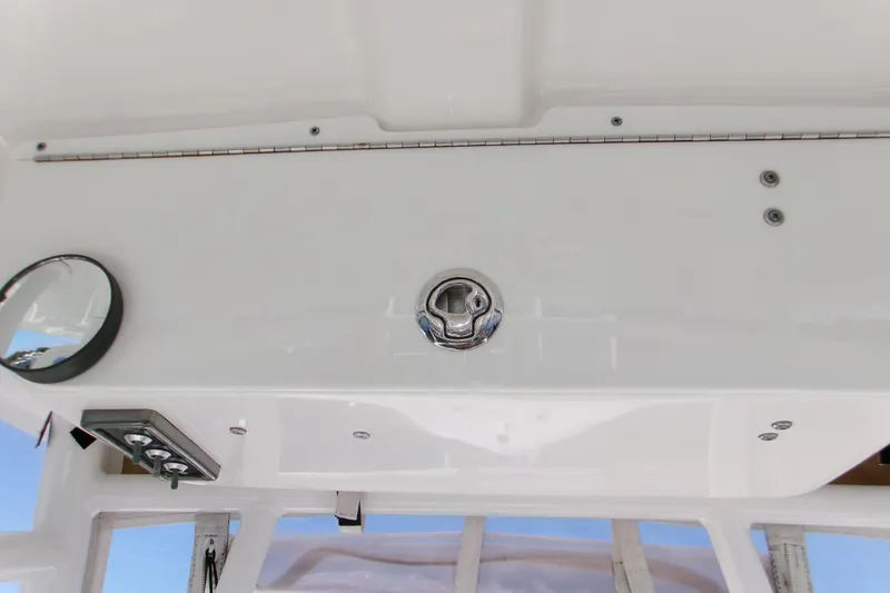 Slide: The Image of 2014 Sportsman Heritage 241 Center Console dashboard with controls and mirror. - 13