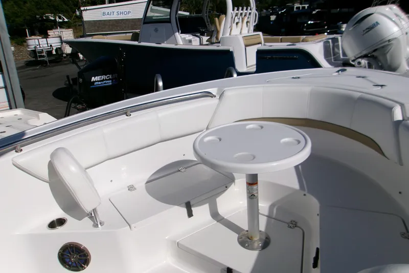 Slide: The Image of 2014 Sportsman Heritage 241 Center Console boat interior with seating and table. - 16