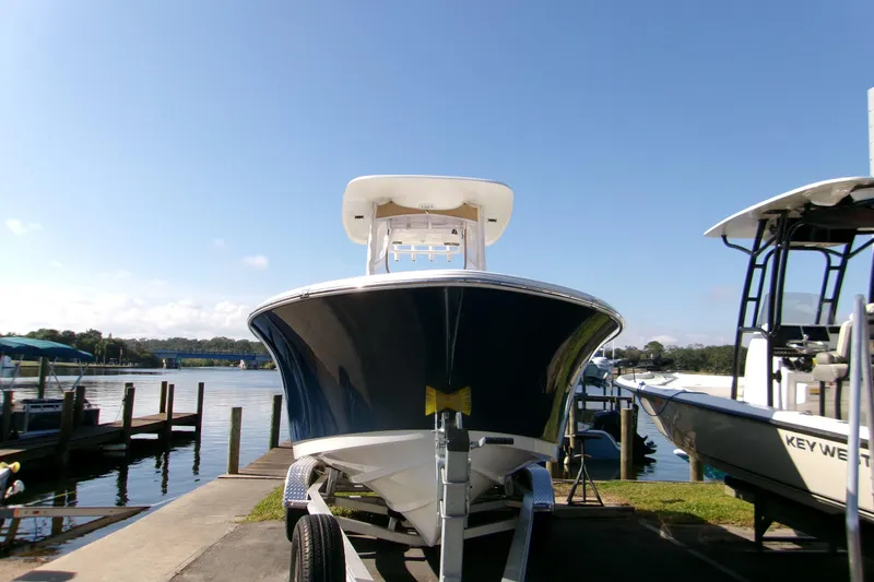 Slide: The Image of 2014 Sportsman Heritage 241 Center Console boat on trailer by the water. - 19