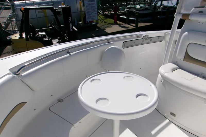 Slide: The Image of 2014 Sportsman Heritage 241 Center Console boat interior with seating and round table. - 5
