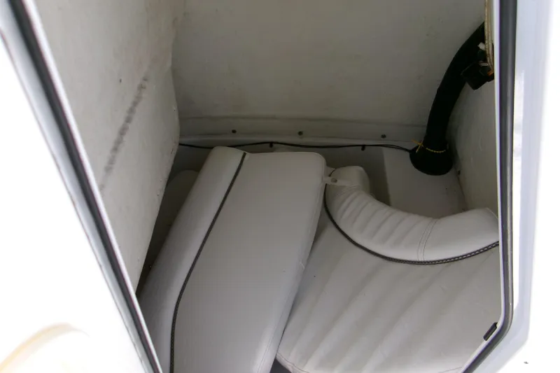 Slide: The Image of 2014 Sportsman Heritage 241 Center Console interior storage compartment with white cushions. - 8