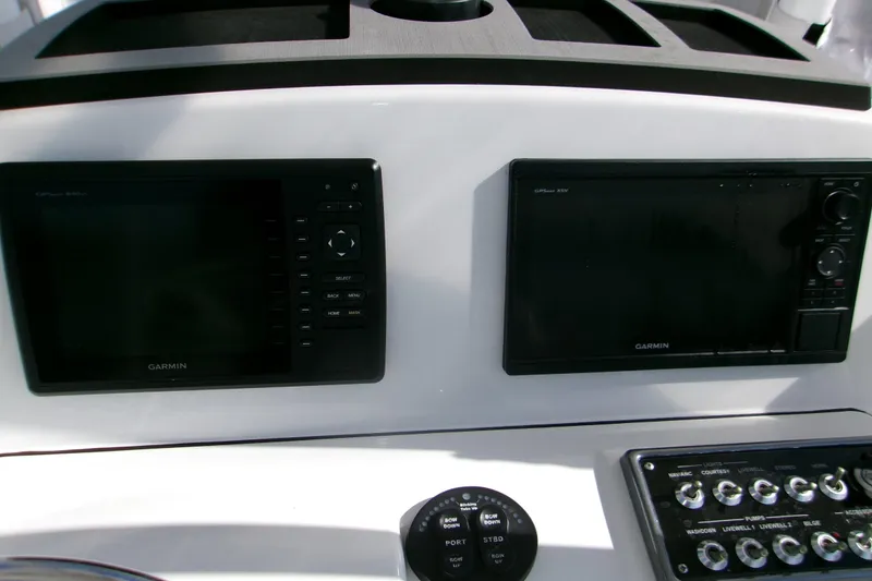 Slide: The Image of Control panel of a 2014 Sportsman Heritage 241 Center Console with Garmin displays. - 9