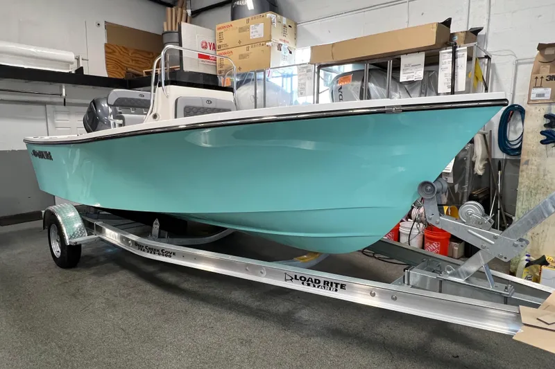 The Image of 2026 Defiance Catalina 190 boat in showroom, turquoise hull on Load Rite trailer. - 0