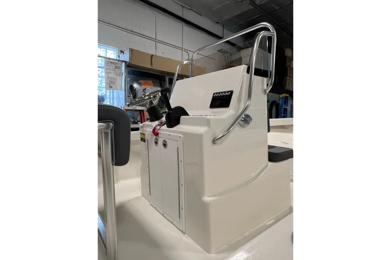 Slide: The Image of 2026 Defiance Catalina 190 boat console with steering wheel and controls in a showroom. - 10