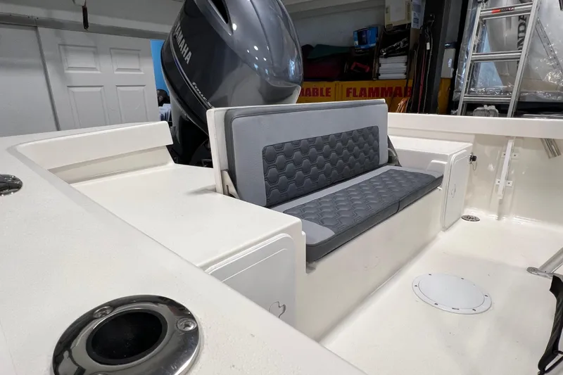 Slide: The Image of 2026 Defiance Catalina 190 boat interior with cushioned seating and Yamaha outboard motor. - 9