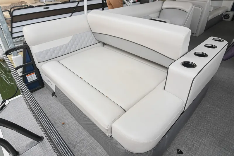 Slide: The Image of 2022 Crest Classic DLX 220 boat interior with white seating and cup holders. - 11