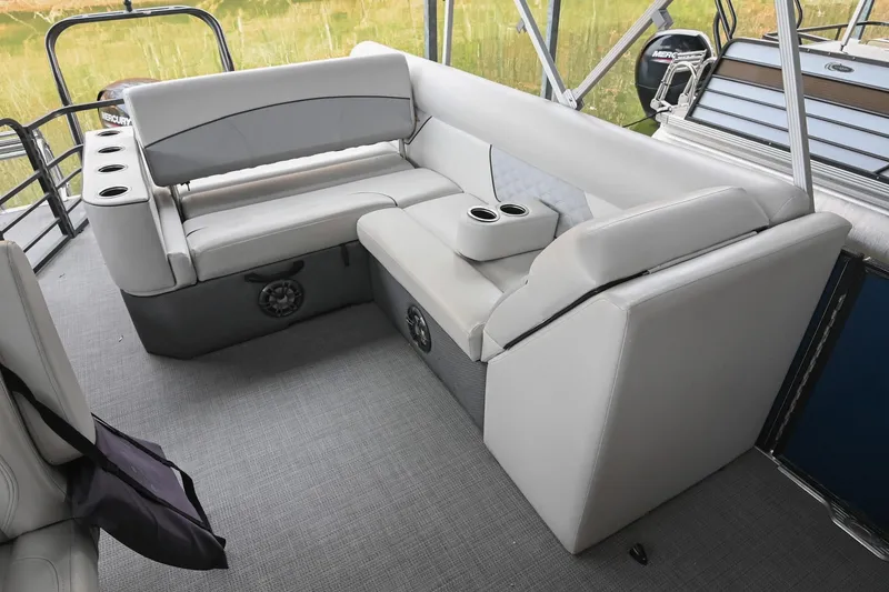 Slide: The Image of 2022 Crest Classic DLX 220 boat interior with gray seating and cup holders. - 15