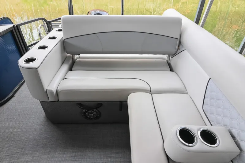 Slide: The Image of 2022 Crest Classic DLX 220 boat interior with plush seating and cup holders. - 17