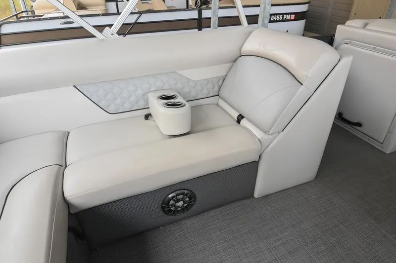 Slide: The Image of 2022 Crest Classic DLX 220 boat interior with beige seating and cup holders. - 18