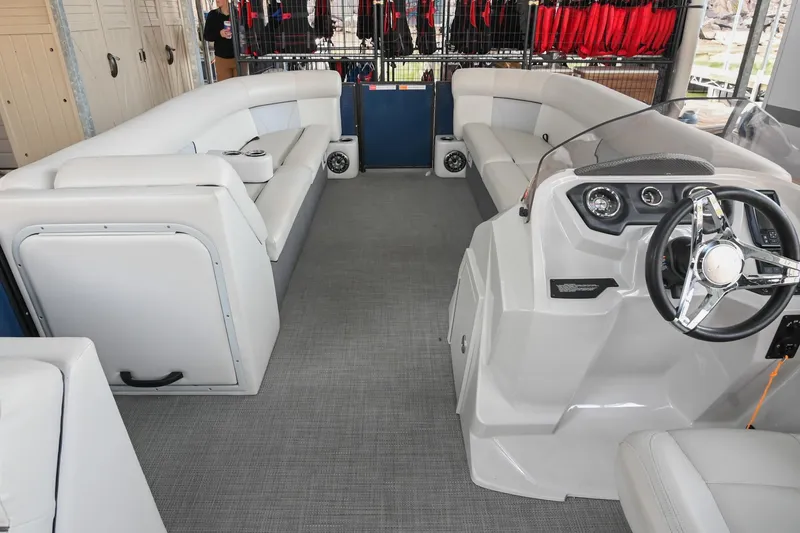 Slide: The Image of 2022 Crest Classic DLX 220 boat interior with plush seating and modern steering console. - 19