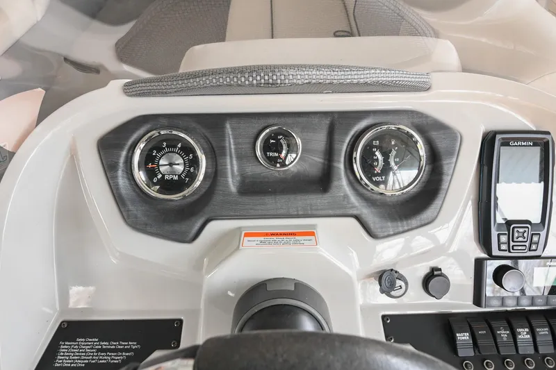 Slide: The Image of Dashboard of 2022 Crest Classic DLX 220 boat with gauges and Garmin device. - 22