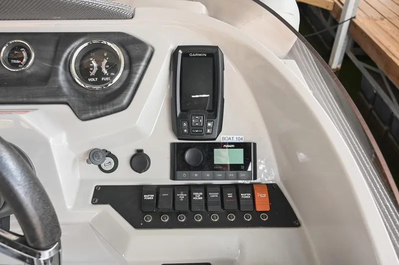Slide: The Image of 2022 Crest Classic DLX 220 boat dashboard with Garmin device and control panel. - 23