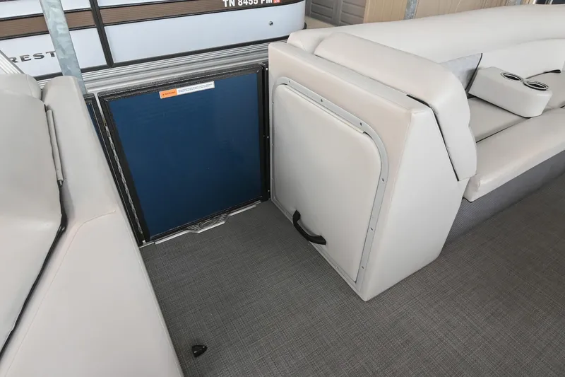 Slide: The Image of 2022 Crest Classic DLX 220 interior with gray seating and storage compartment. - 26