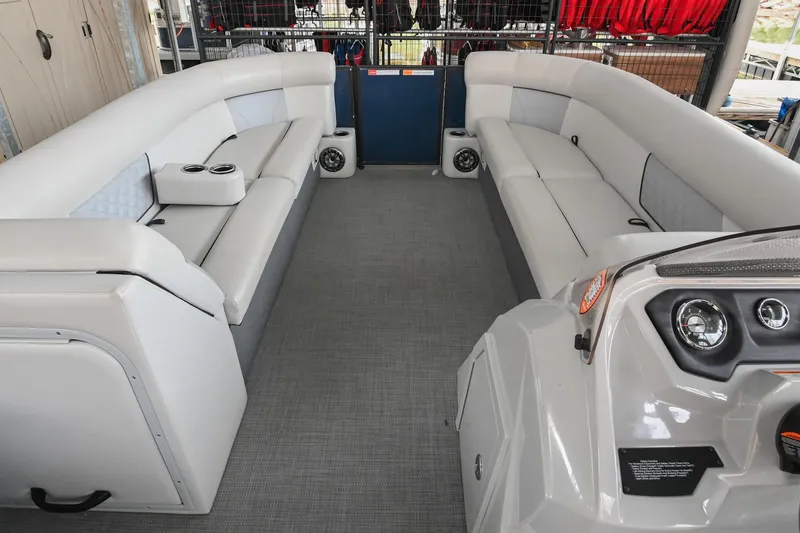Slide: The Image of 2022 Crest Classic DLX 220 boat interior with spacious seating and modern dashboard. - 27
