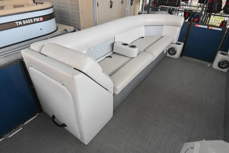 Slide: The Image of 2022 Crest Classic DLX 220 boat interior with plush seating and cup holders. - 28
