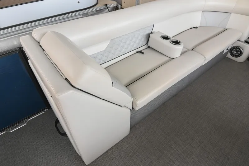 Slide: The Image of 2022 Crest Classic DLX 220 boat interior with plush seating and cup holders. - 29