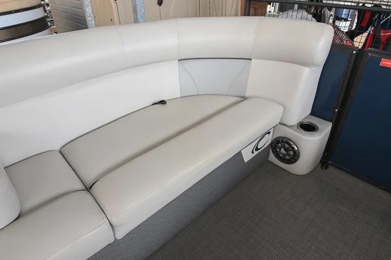 Slide: The Image of 2022 Crest Classic DLX 220 boat interior with plush seating and speaker system. - 31