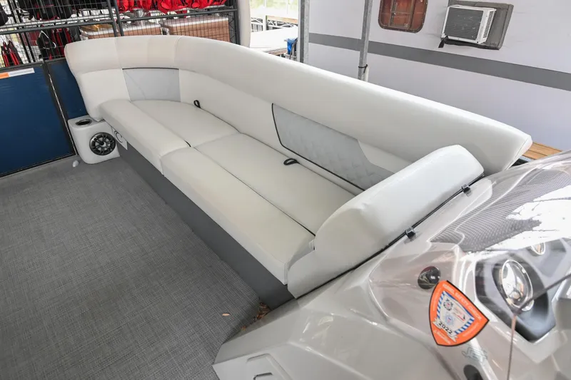 Slide: The Image of 2022 Crest Classic DLX 220 boat interior with white seating and modern design. - 32