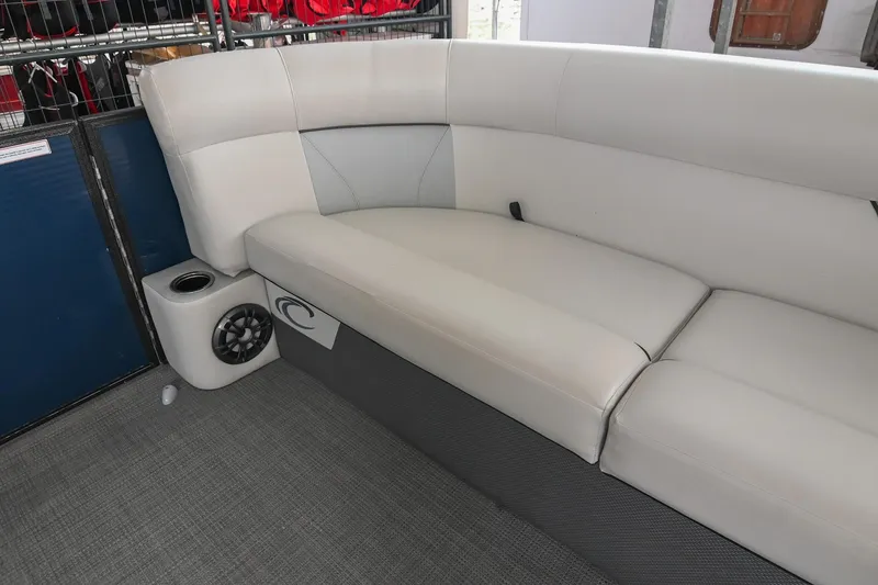 Slide: The Image of 2022 Crest Classic DLX 220 boat interior with white seating and speaker system. - 34