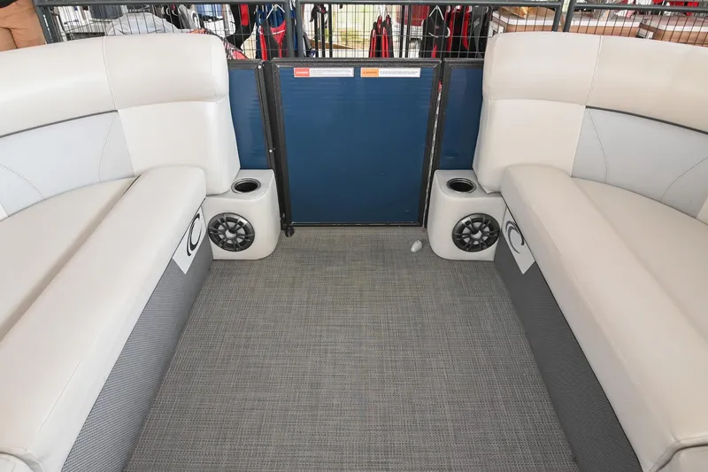 Slide: The Image of Interior of 2022 Crest Classic DLX 220 pontoon boat with beige seating and speakers. - 35