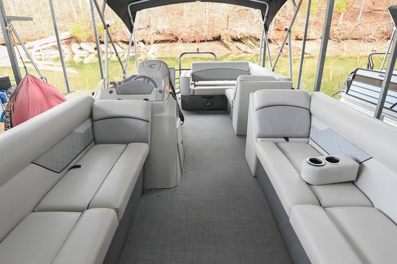 Slide: The Image of 2022 Crest Classic DLX 220 pontoon boat interior with spacious seating and cup holders. - 6
