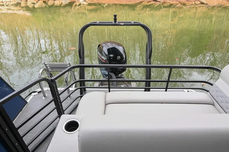 Slide: The Image of 2022 Crest Classic DLX 220 pontoon boat with Mercury outboard motor on a calm lake. - 7