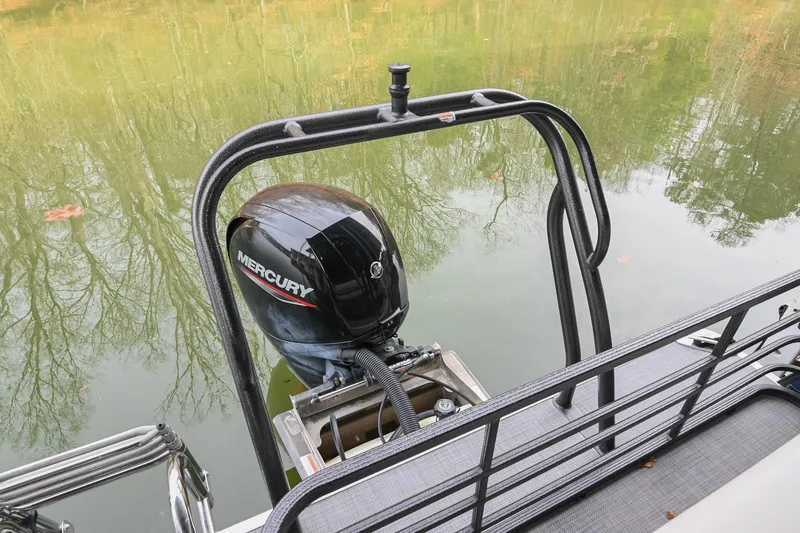 Slide: The Image of 2022 Crest Classic DLX 220 pontoon boat with Mercury outboard motor on calm water. - 8