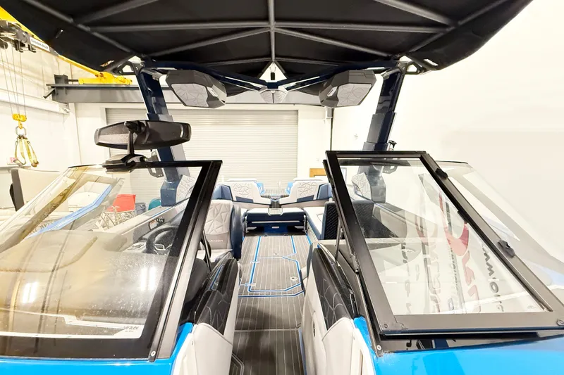 Slide: The Image of 2022 Nautique Super Air Nautique G25 Paragon interior with open windshield and luxury seating. - 5