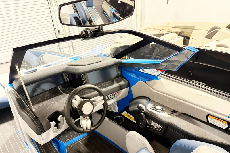 Slide: The Image of 2022 Nautique Super Air Nautique G25 Paragon cockpit with modern steering and controls. - 7