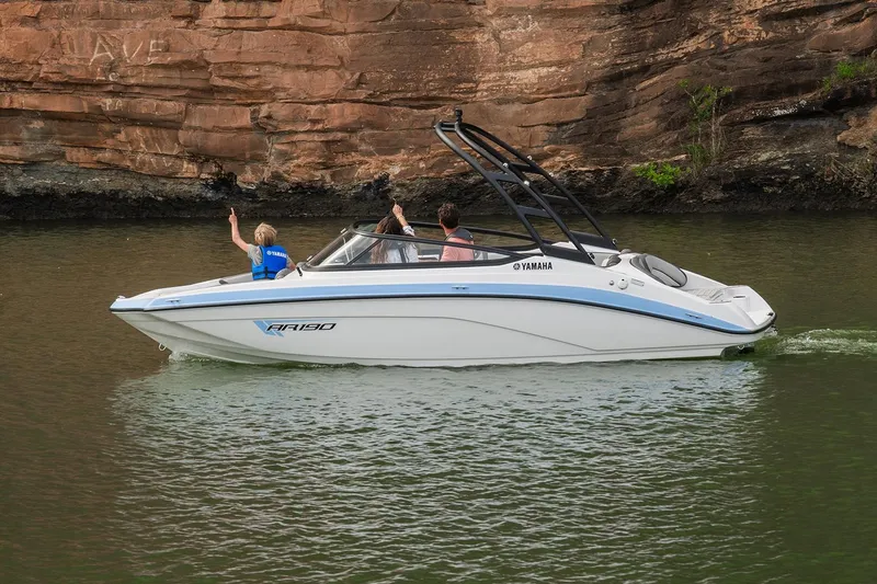 Slide: The Image of Manufacturer Provided Image: 2026 Yamaha Boats AR190 cruising on a scenic river near rocky cliffs. - 1