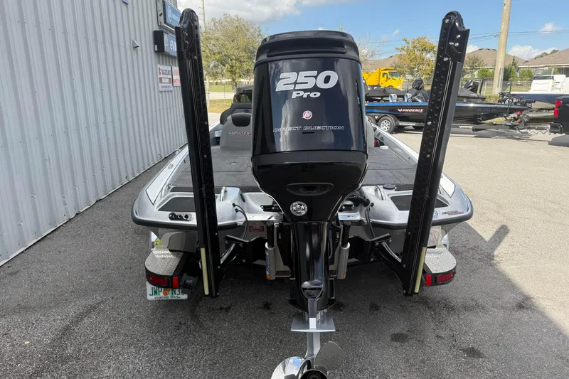 Slide: The Image of 2018 Phoenix 721 ProXP boat with 250 Pro engine, parked outdoors. - 12