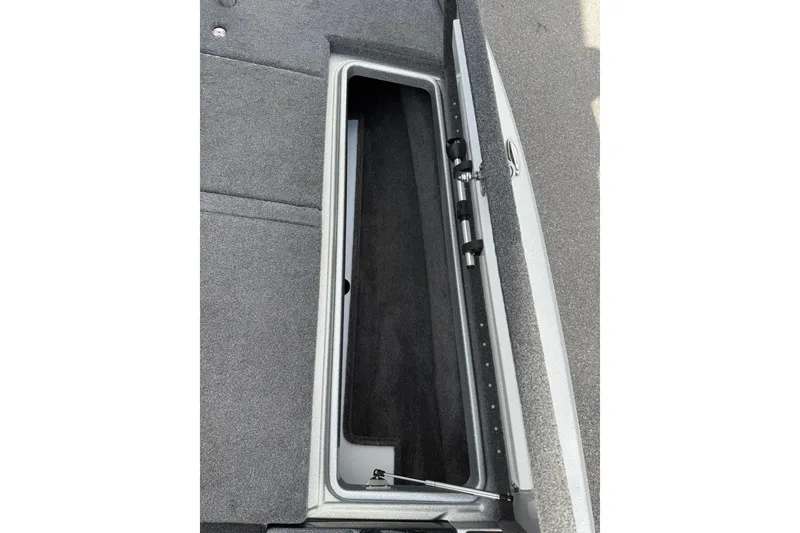 Slide: The Image of Open storage compartment in 2018 Phoenix 721 ProXP boat, featuring carpeted interior. - 7
