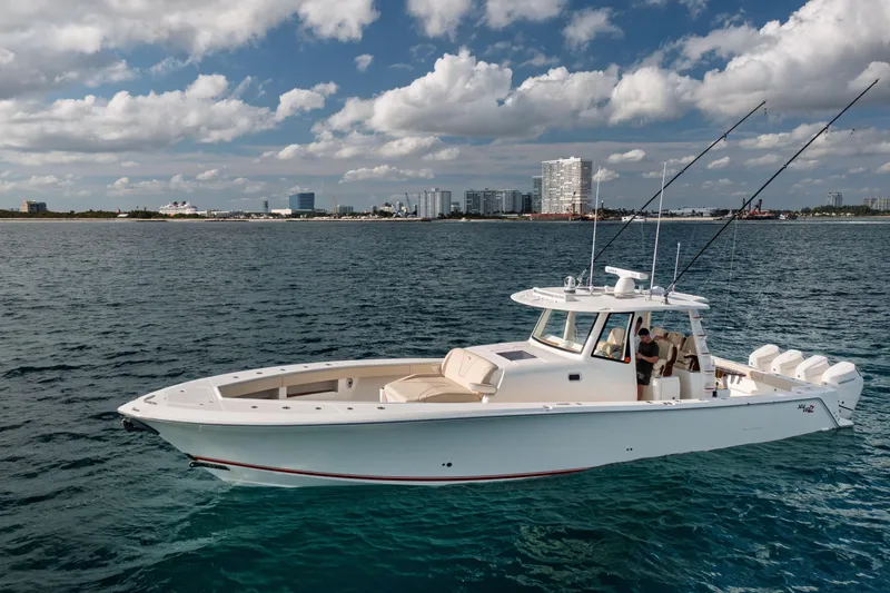 Slide: The Image of 2022 SeaVee 450Z boat on calm water with city skyline in background. - 0