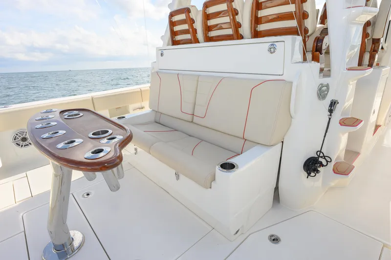Slide: The Image of 2022 SeaVee 450Z boat interior with seating and rod holders, ocean view. - 11