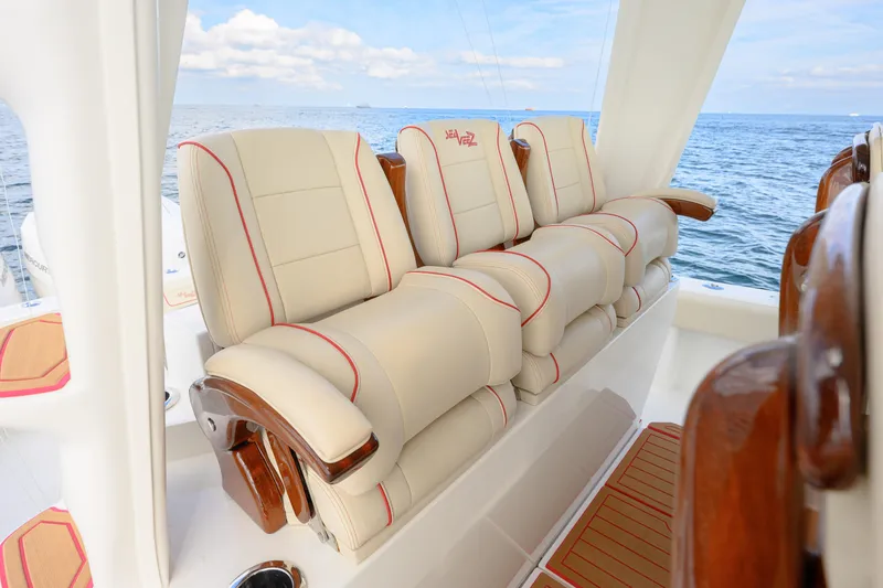 Slide: The Image of Luxurious seating on 2022 SeaVee 450Z boat, featuring cream upholstery with red accents. - 13